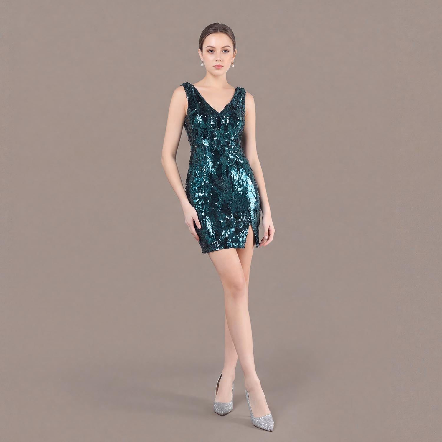 Emerald forest green radiant V-neck sequin mini dress with side slit detail, shown as a shimmering cocktail and party gown.